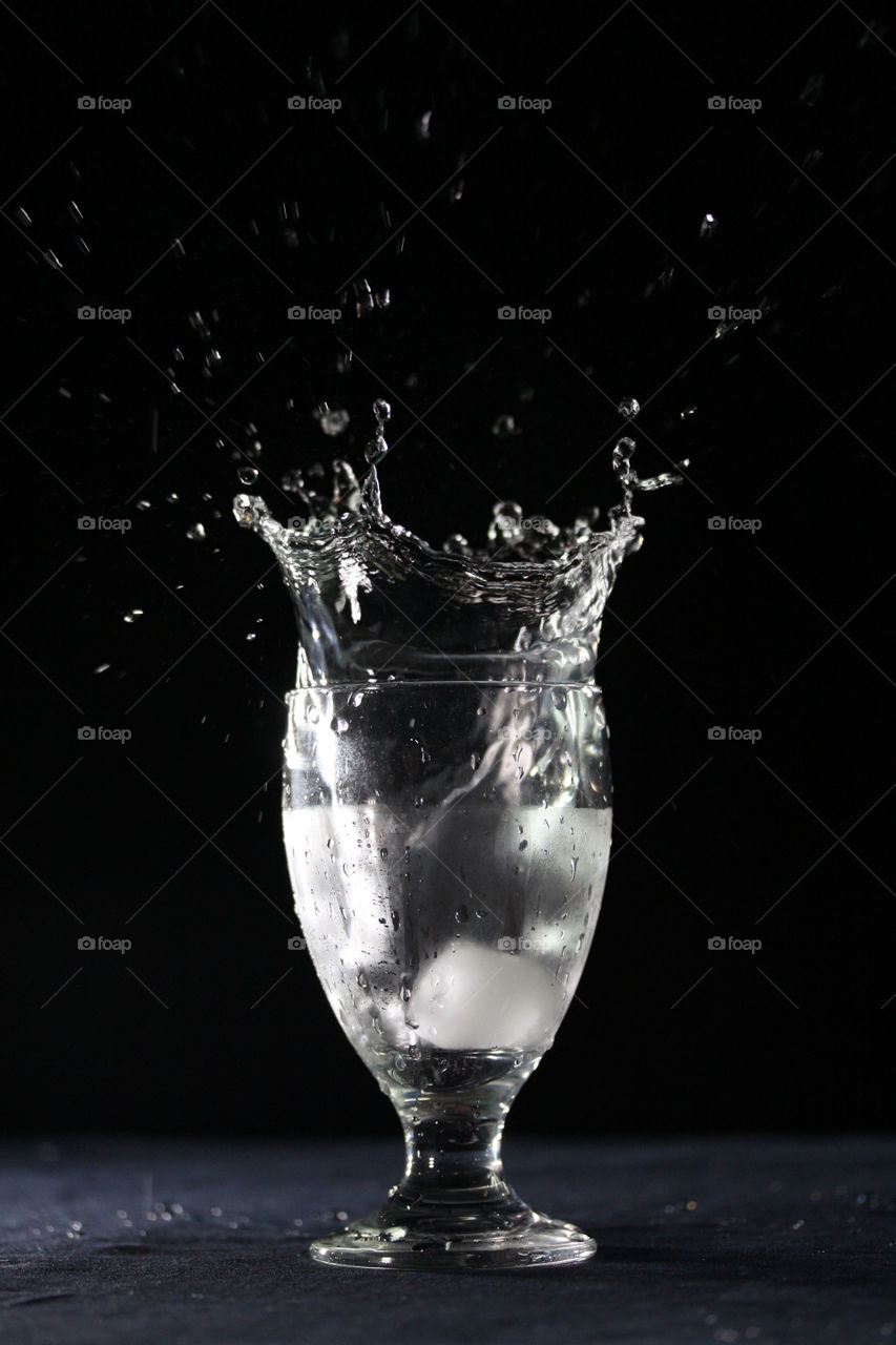 Crown splash in a glass of icy water