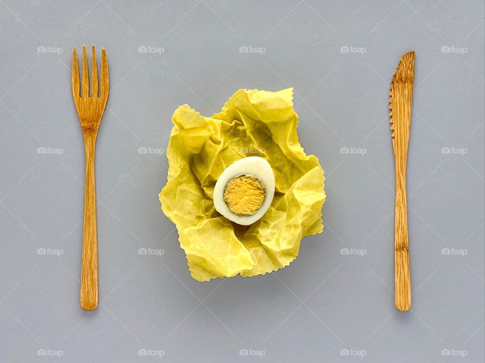 Wooden fork and knife on gray background, egg, food, eco