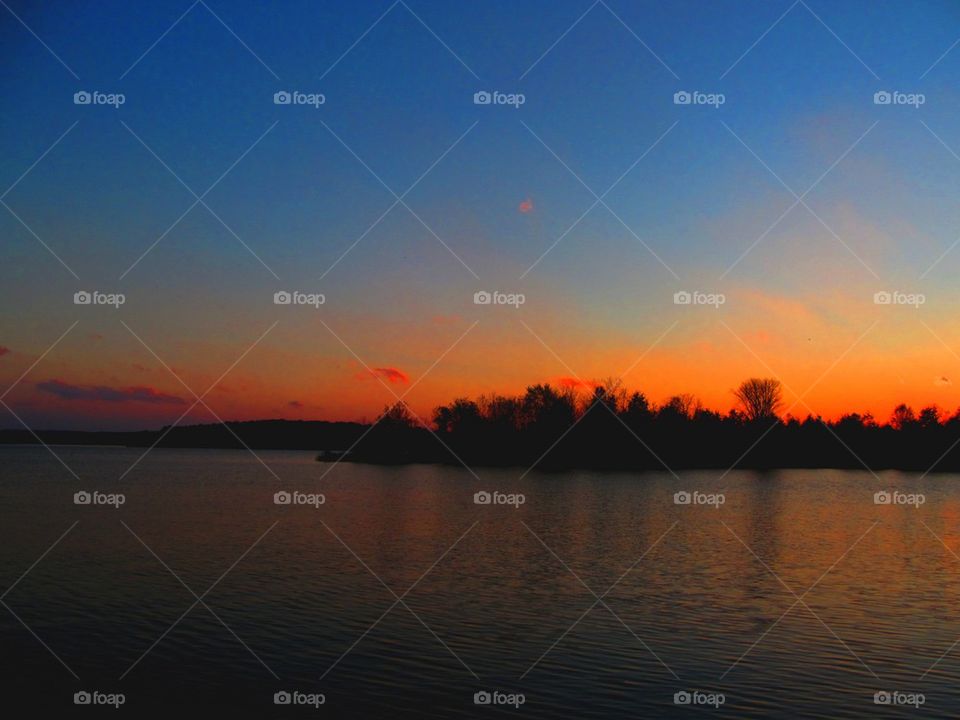 Island on local reservoir with late fall sunset in recess 