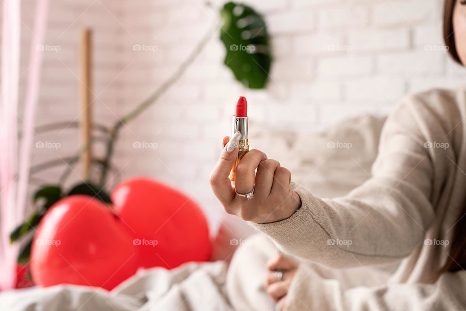 woman using cosmetics at home