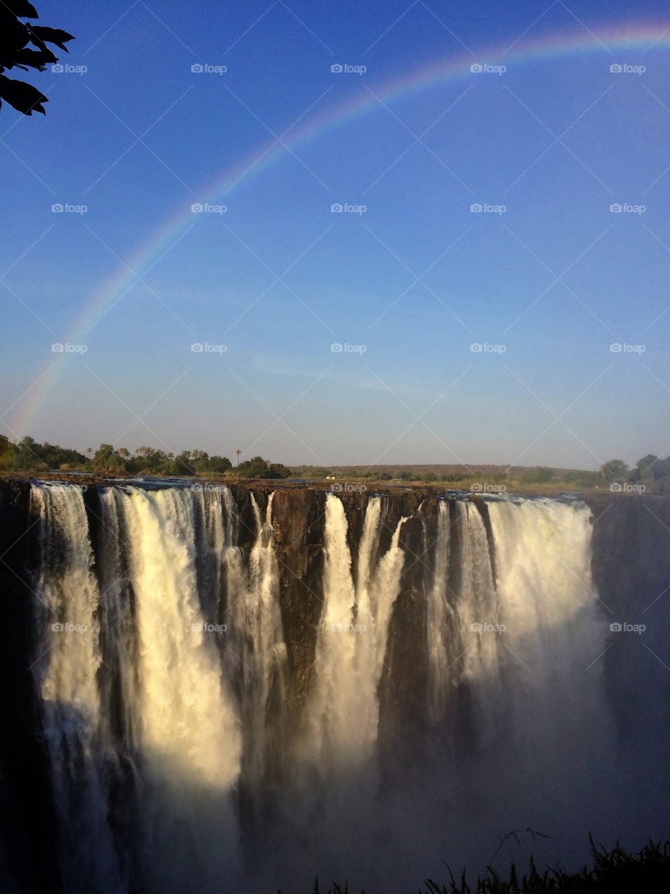 Waterfall against rainbow