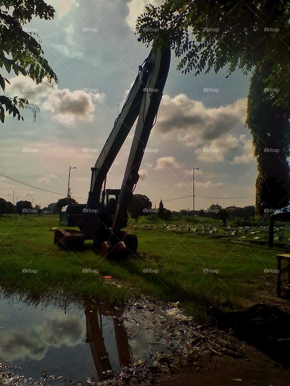 This machine is heavy equipment for dredging land in public cemetery grave parks