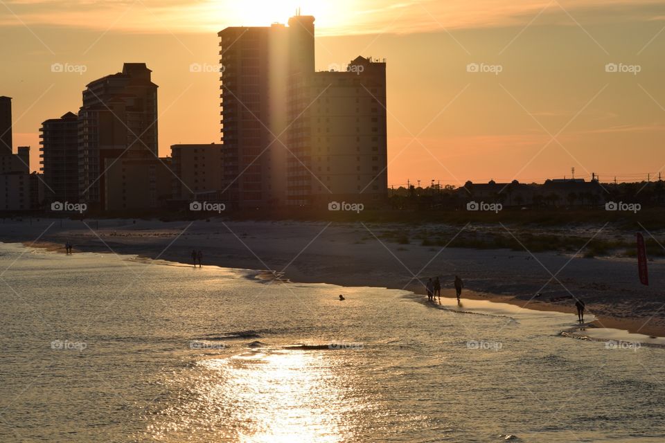 Gulf shores at sunset. Buildings and the beach at sunset