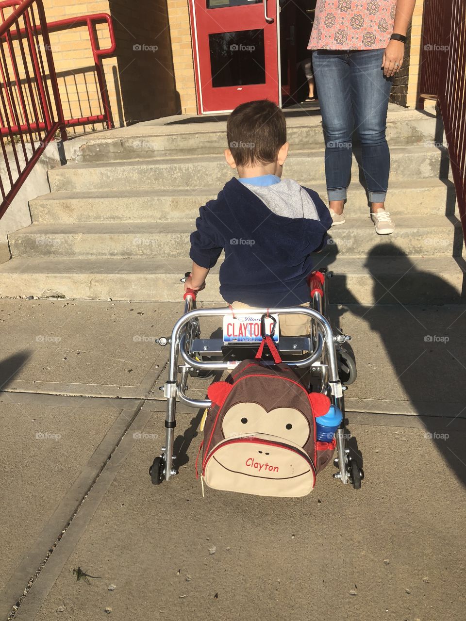 Special needs boy with walker on his way to school