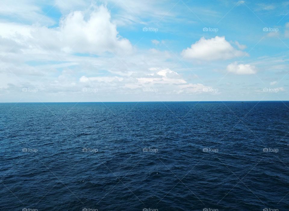 The beauty of the sea, sky and clouds.