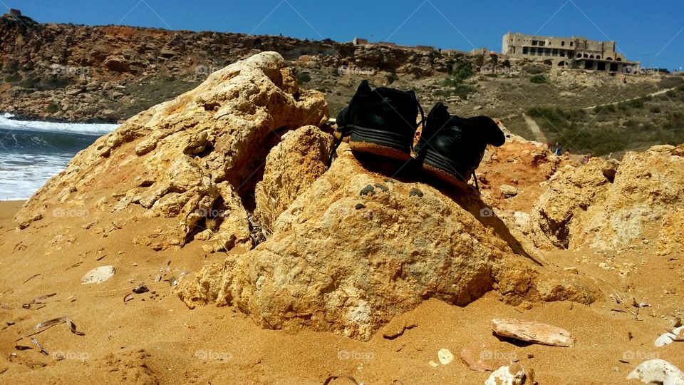 Looking at my shoes on the beach