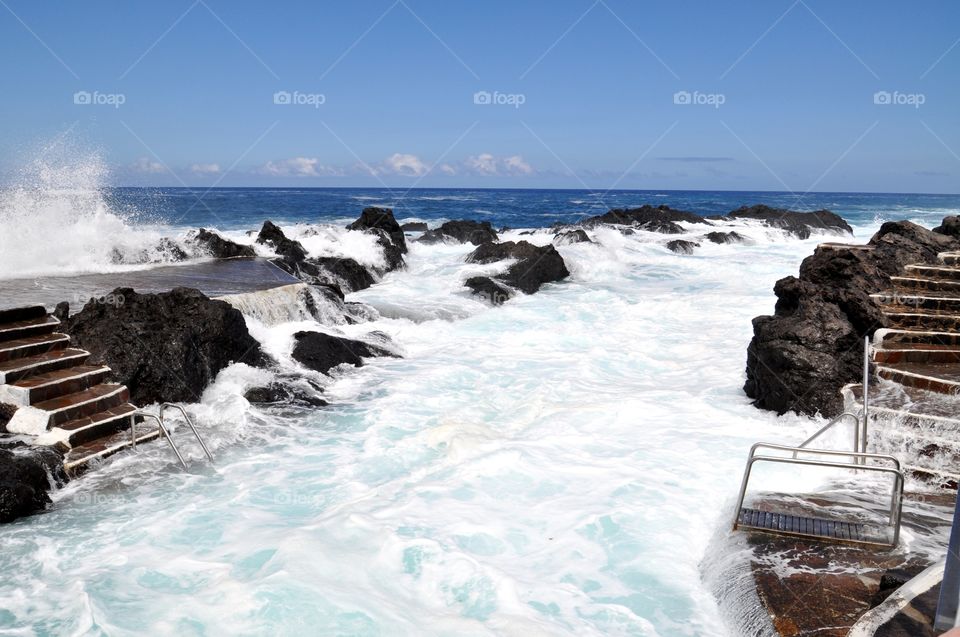 Waves crashing on rock