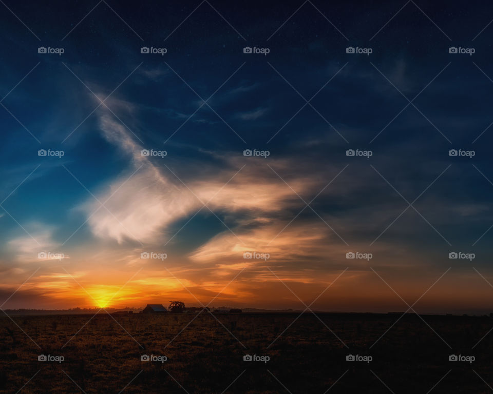 Dramatic sky over the field at sunset