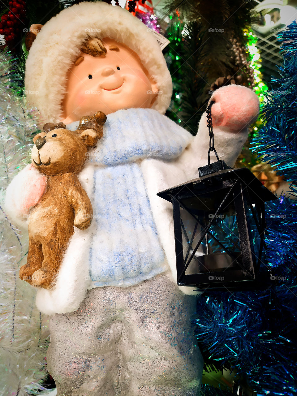 Toy.  The boy who holds the bear and the lantern