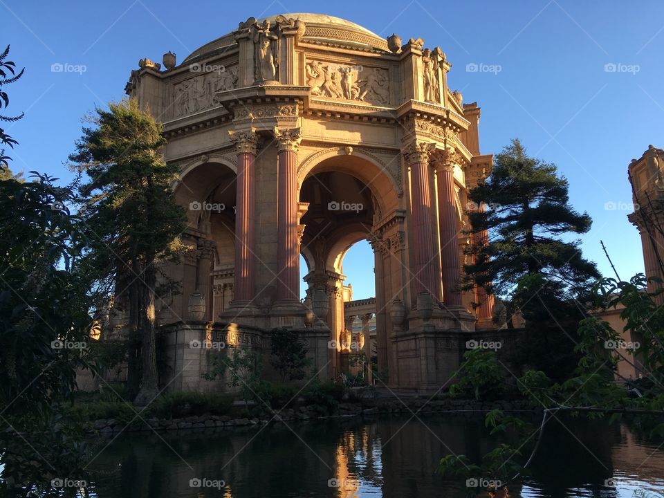 Arched building with sculptures in golden hour 