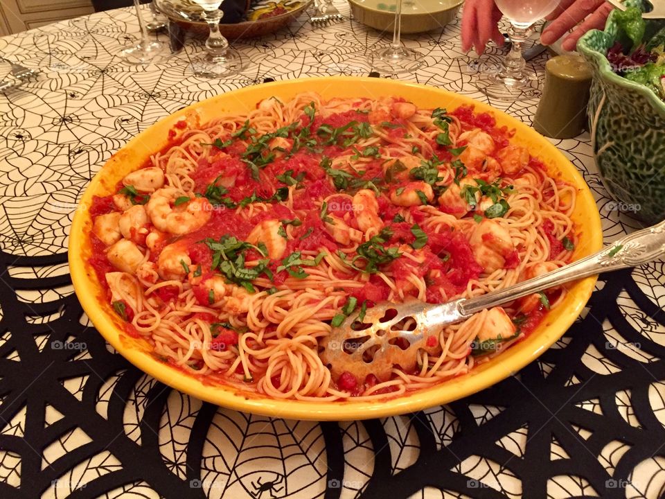 Seafood pasta with shrimp scallops garlic and tomatoes 