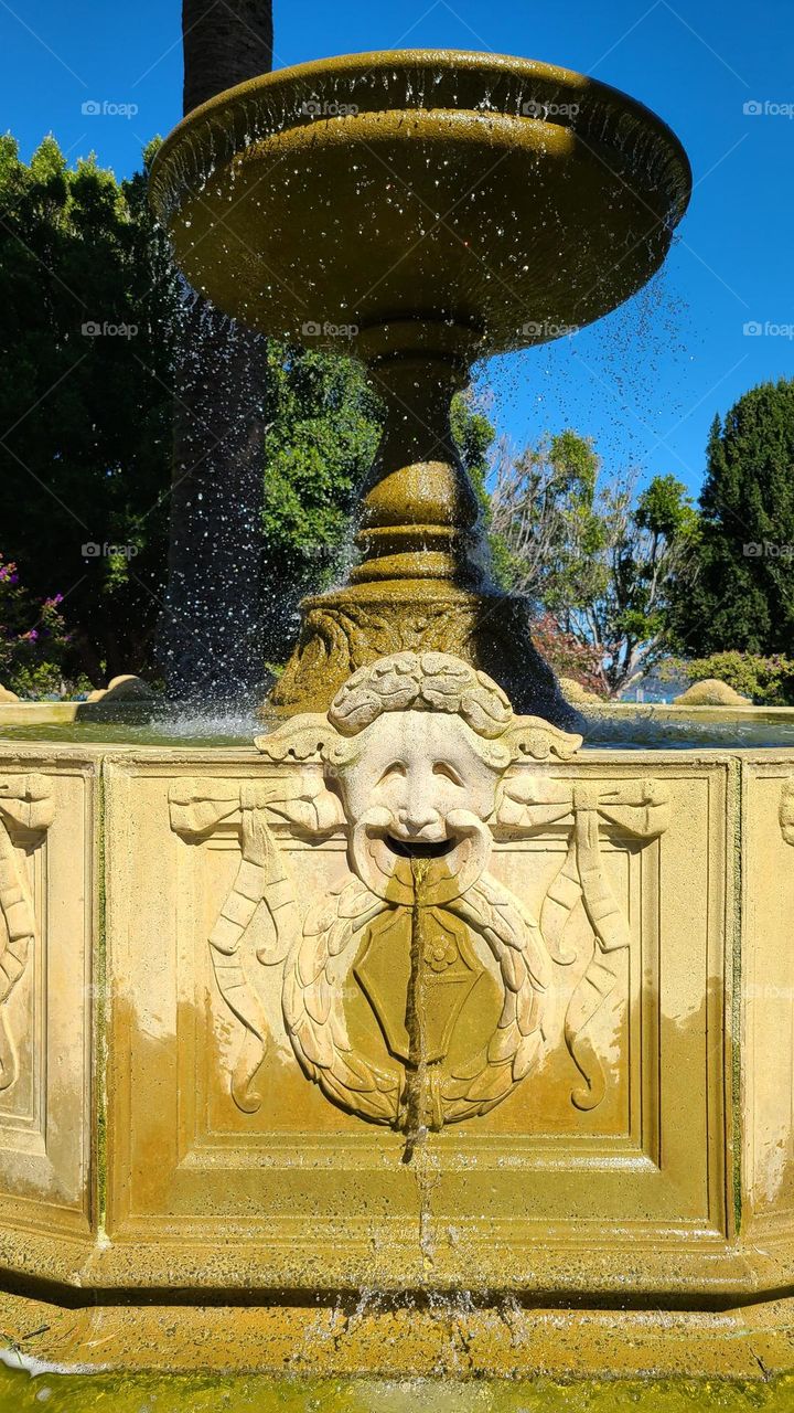 Water fountain in the Central Park area of Sausalito California on a warm summer afternoon with the water flowing and splashing around 