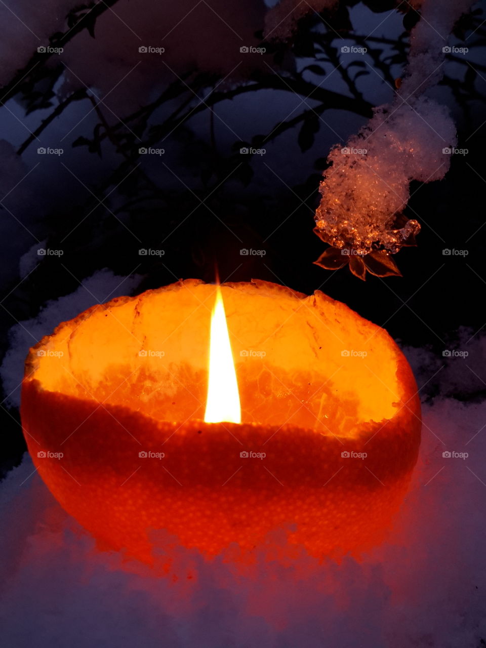 Burning candle in orange peel