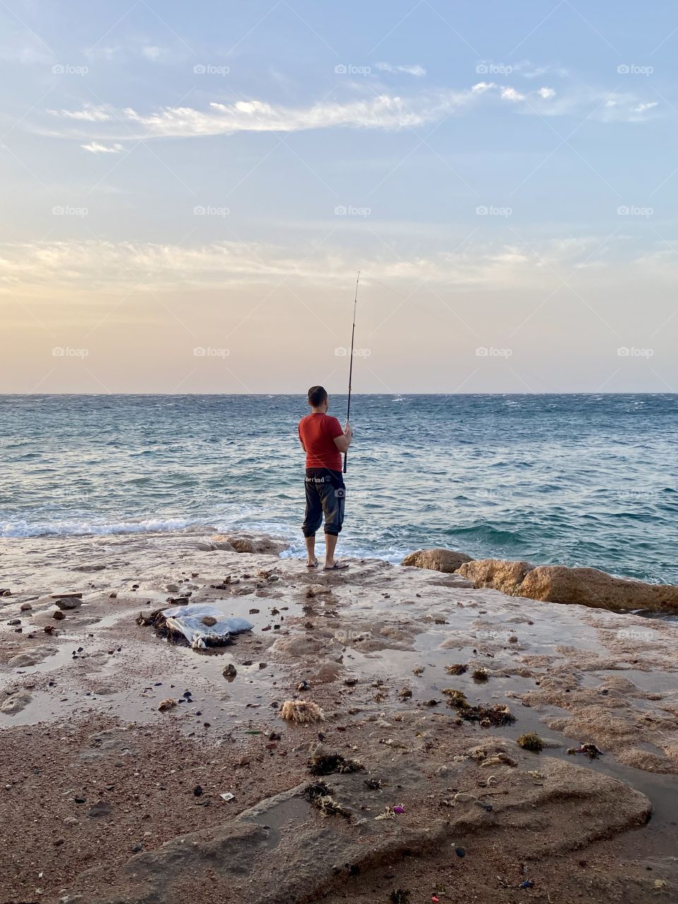 Lonely fisherman at dawn.