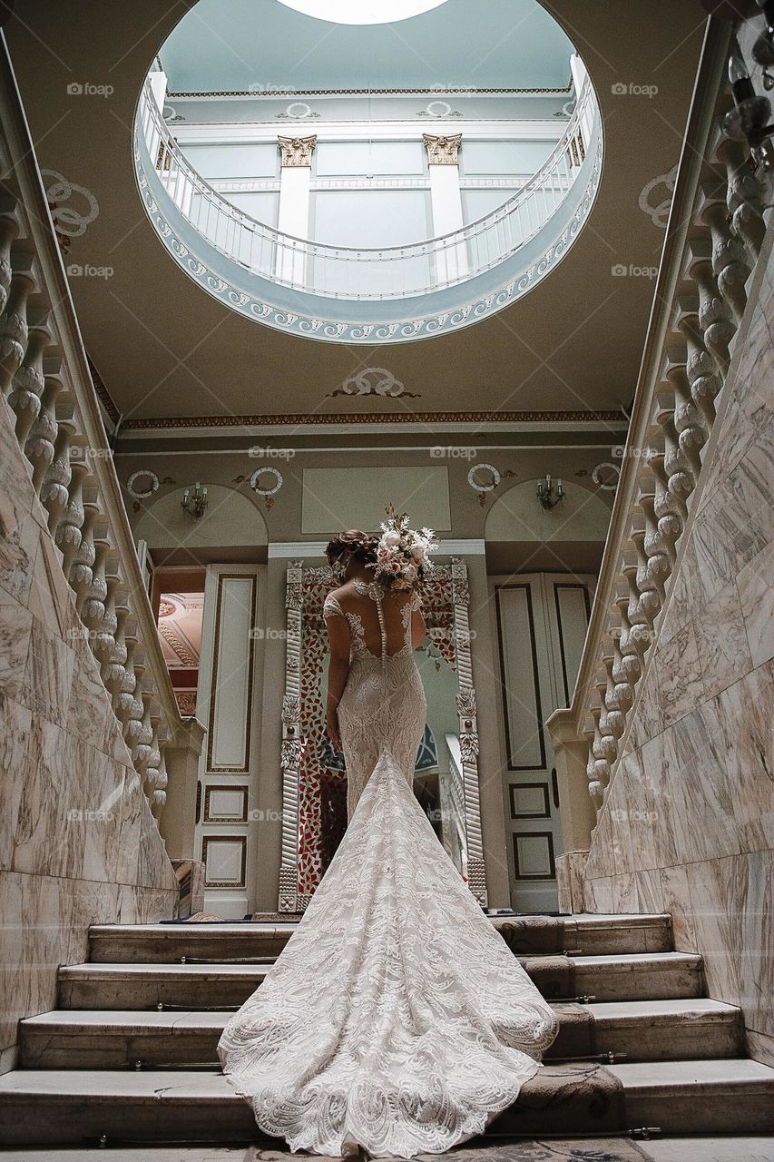 Bride in wedding dress with flowers bouquet