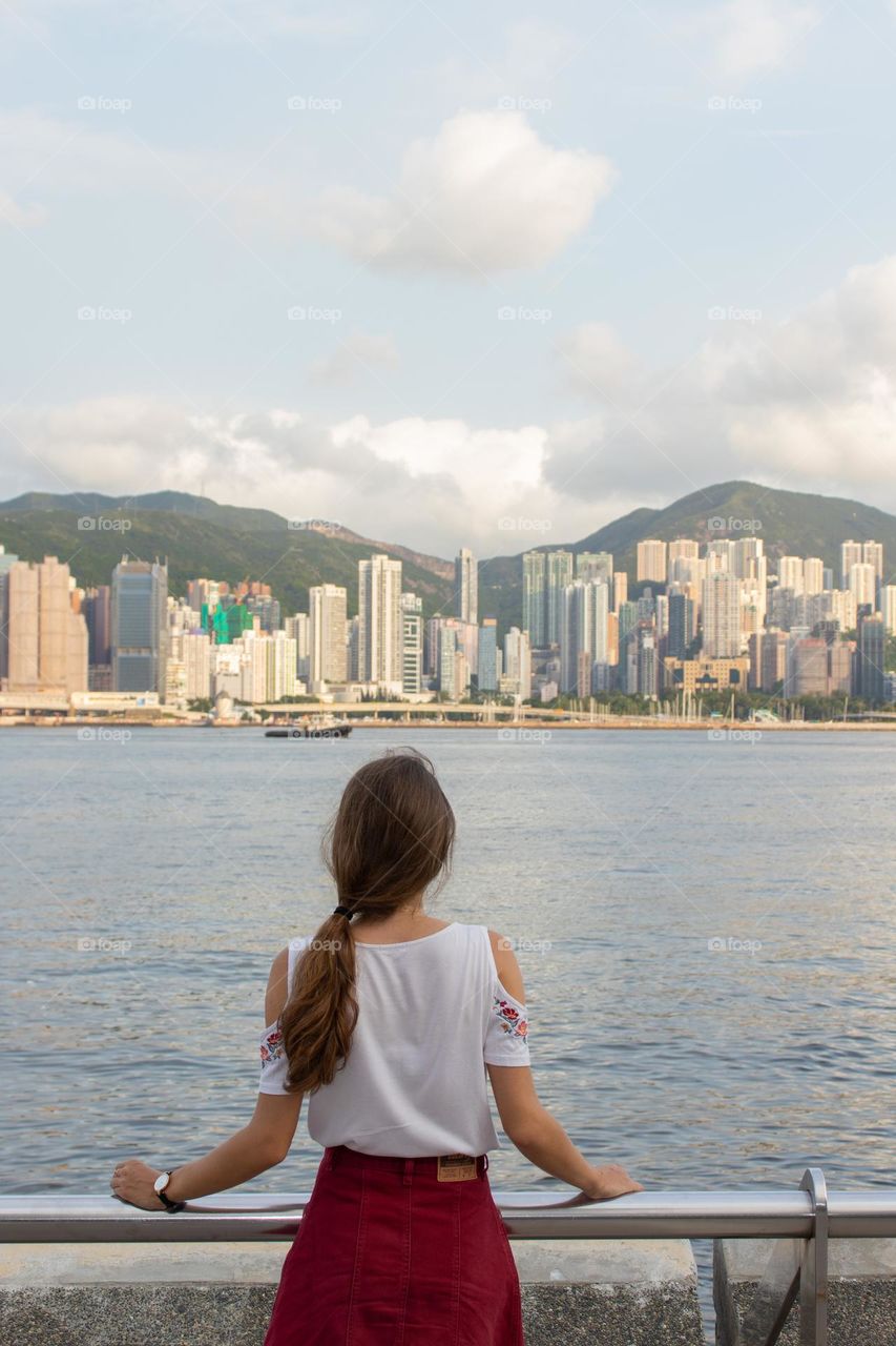 Young woman enjoying the city view in Hong Kong 