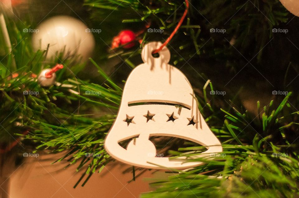 White wooden bell as an element of Christmas tree decoration 