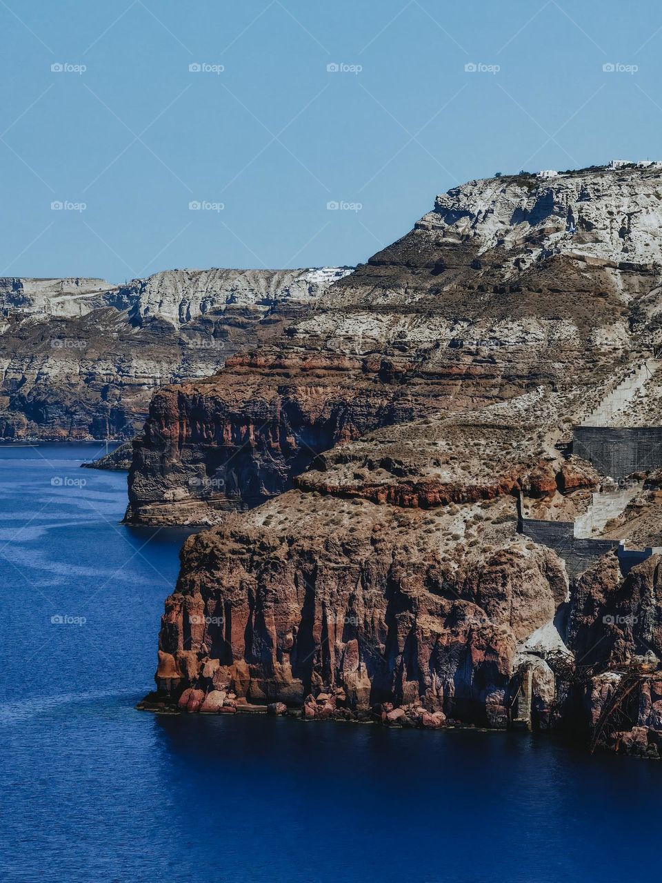 Mountain of the Santorini island above blue sea