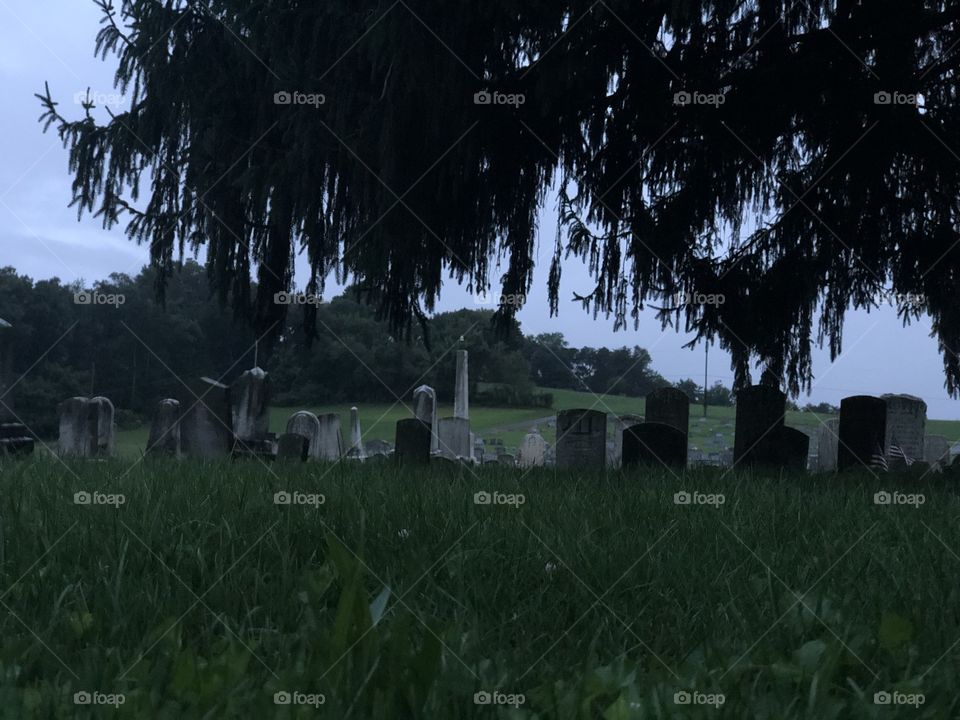 Headstones at the cemetery on a rainy day 