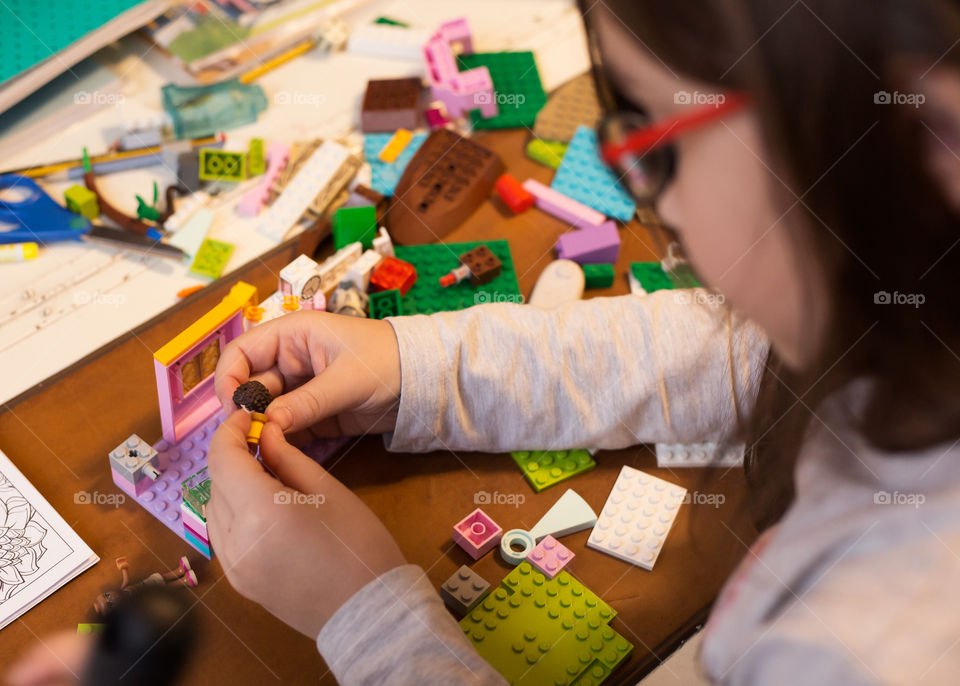 Little girl building from blocks