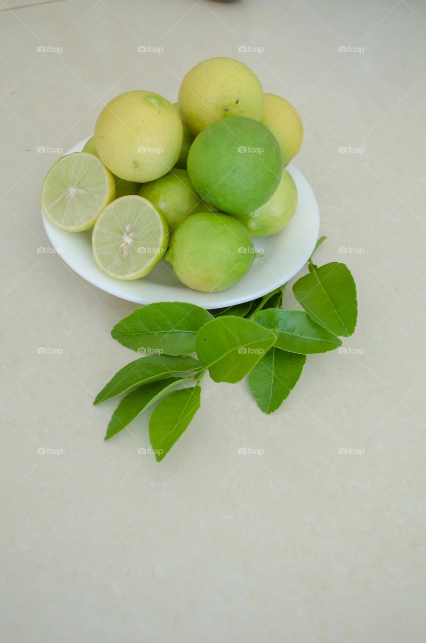 Ripe And Unripe Key Limes Stocked In A Plate