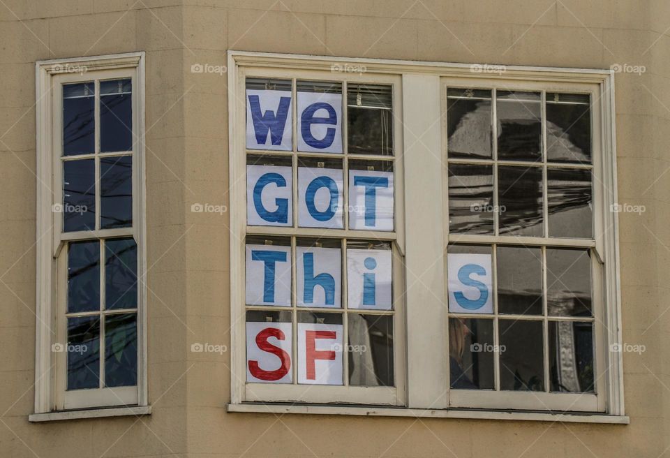 Window in San Francisco during the pandemic with a message of encouragement and support in the window 