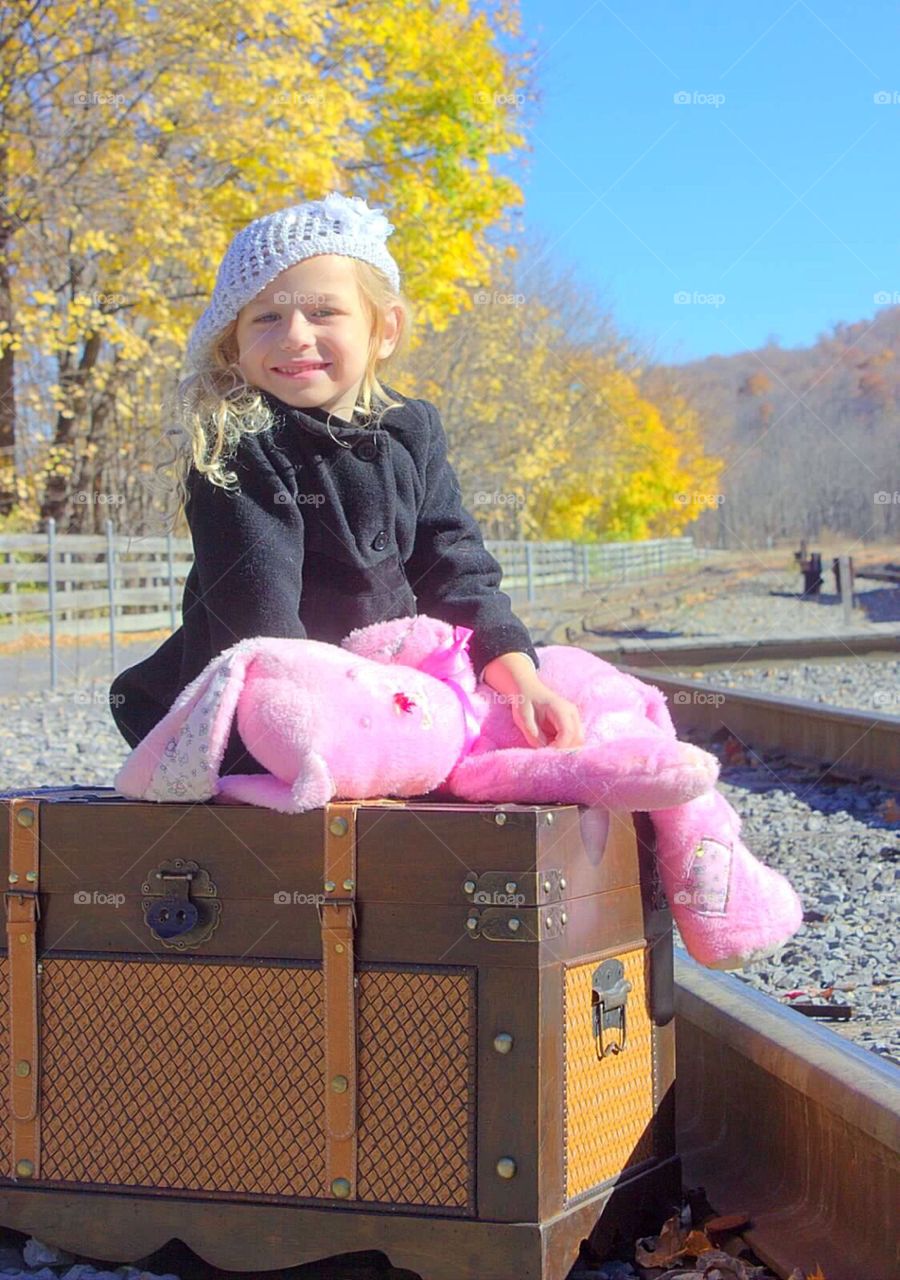 Portrait of a smiling girl holding stuffed toy