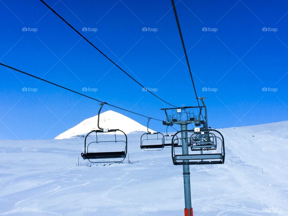 Empty ski lifts on a clear blue sky day