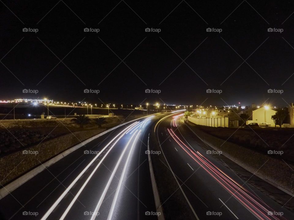 luces de coches en la carretera de noche, formando estelas de luces creado por una larga exposición fotográfica.