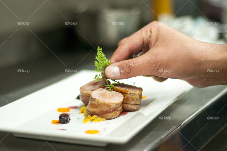Chef adding finishing touches to a dish