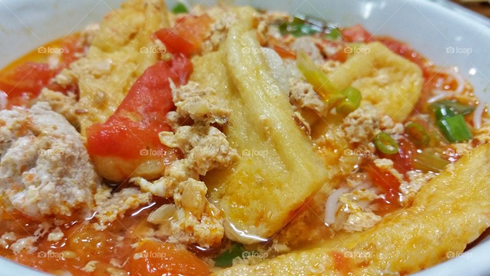 Vietnamese crab noodle soup (Bun Rieu); a close up view.