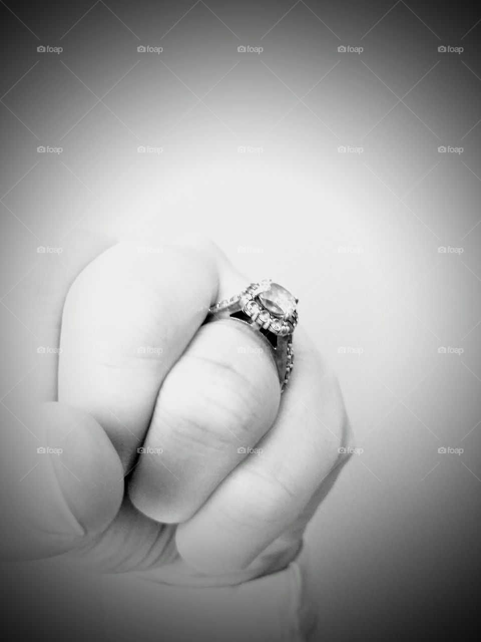 making a fist with a wedding ring on