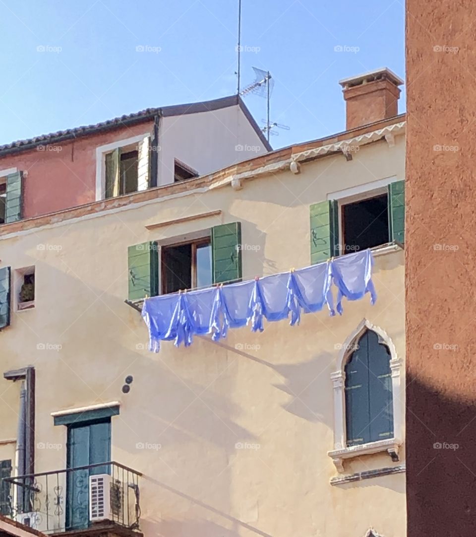 Blue shirts on drying in Venice