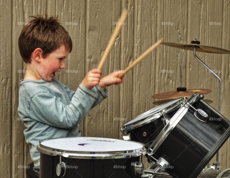 Boy Rocking Out On Drums