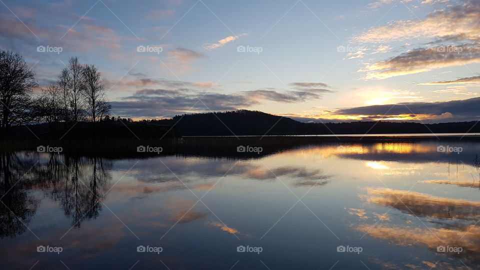 Swedish landscape in late autumn, sunset over mirror lake - solnedgång över  spegelblank sjö på sen höst , natur landskap Sverige