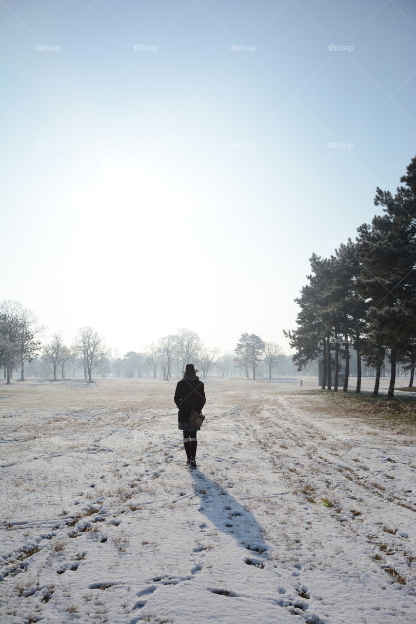 Rear view of a woman walking in winter