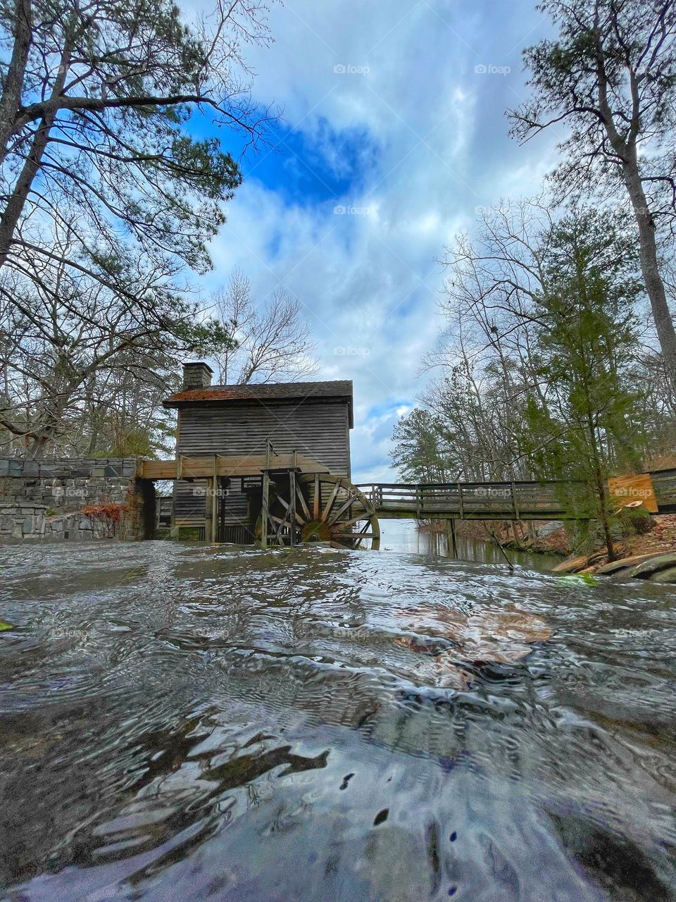 Old wooden mill house next to a beautiful river in Georgia 