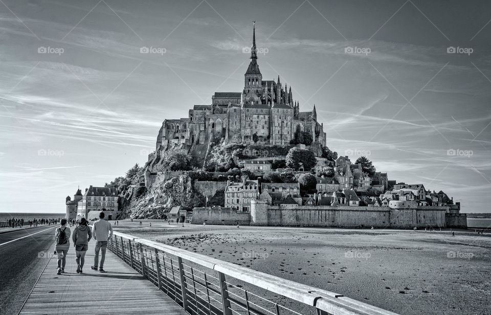 Tourists walk towards Mont Saint-Michel, France