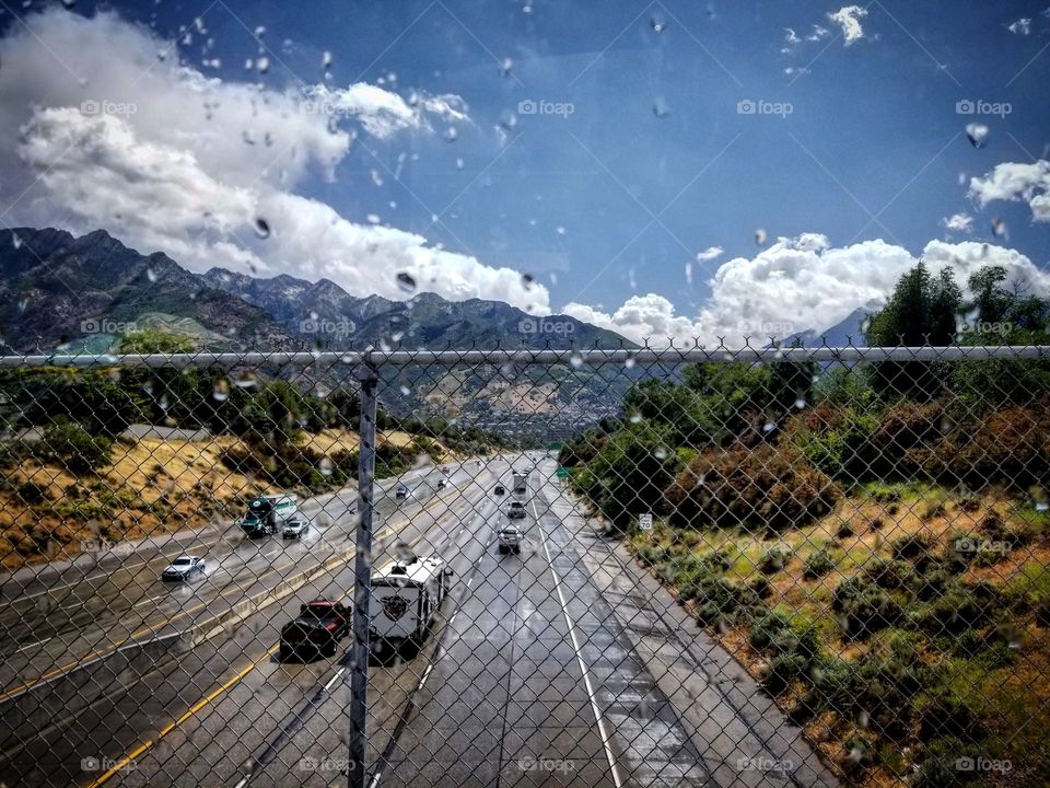 beautiful blue skies with white clouds all around mountains of the east green trees and the 🛣️freeway😊