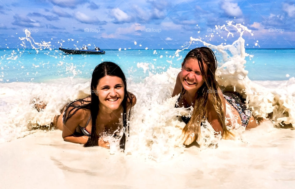 Two teenage girls enjoying in the waves