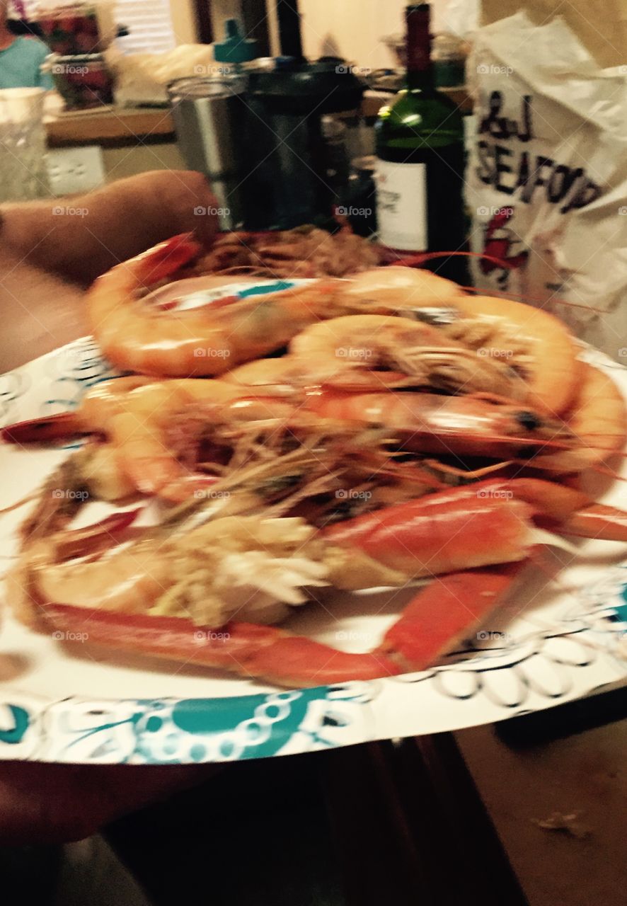 Seafood, showing crab legs, and shrimp on s plate looking delicious. 