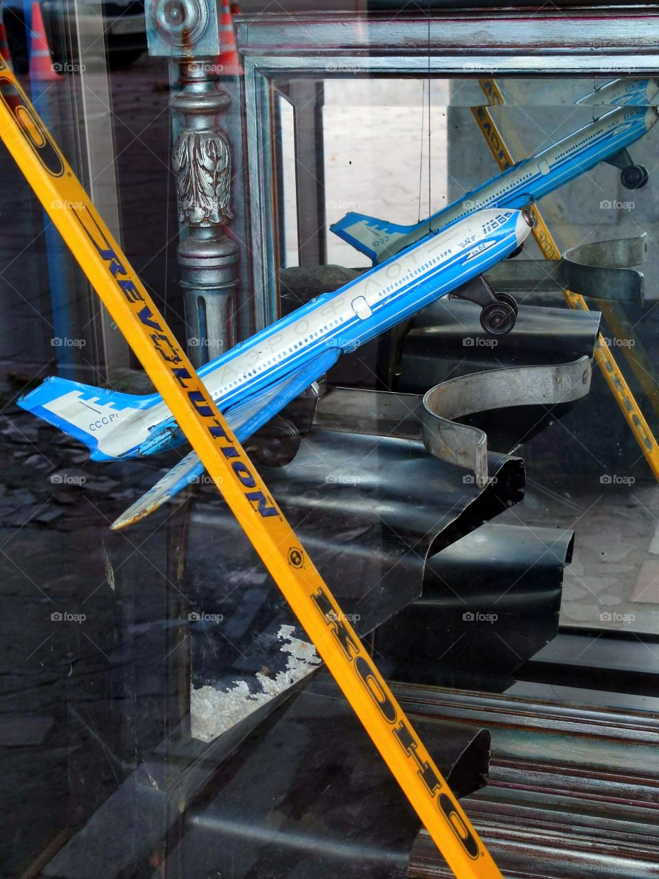Showcase of the sports hockey complex: "Wings of the Soviets". Composition. A large mirror in which a model of a blue IL-62 aircraft is reflected and a wooden handle of a hockey stick