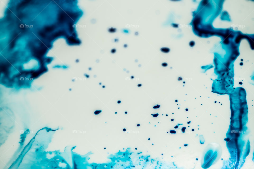 The ink to refill the printer cartridge was spilled onto the white washbasin and the paints blended into abstract drips and patterns.