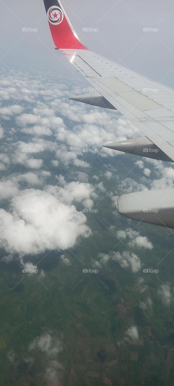 clouds and airplane wings viewed from Airplane window seat