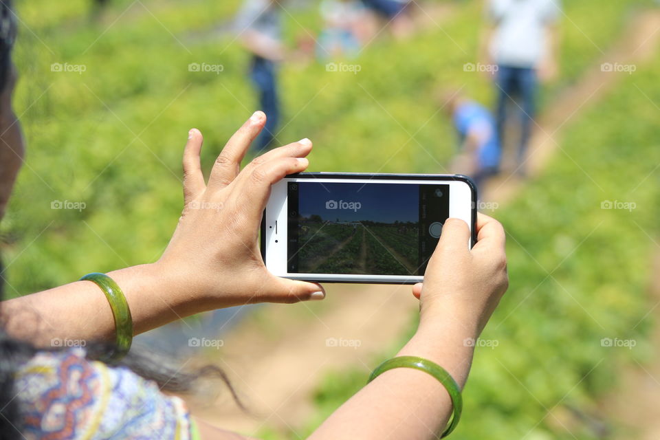 young woman snapping photo from her phone 