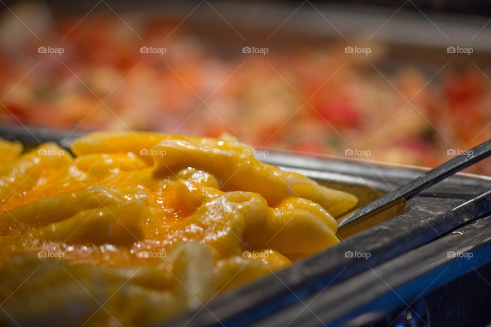 Mac and cheese preparing in cooking pan