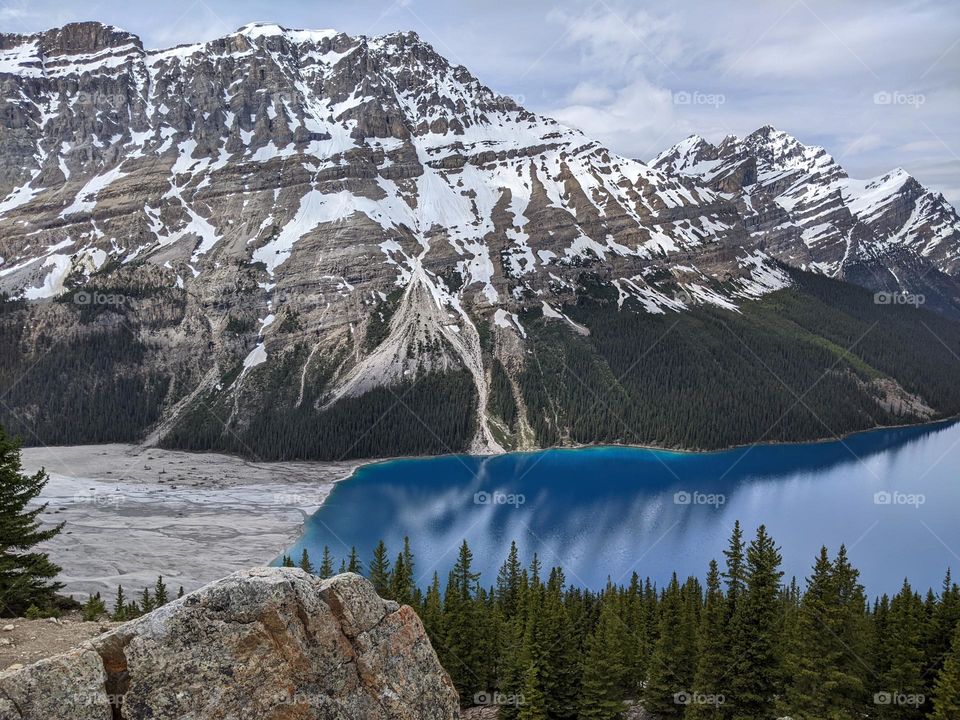 the mountain range and shore at Peyto lake in Banff national park. The deep Blue lake works as a mirror.