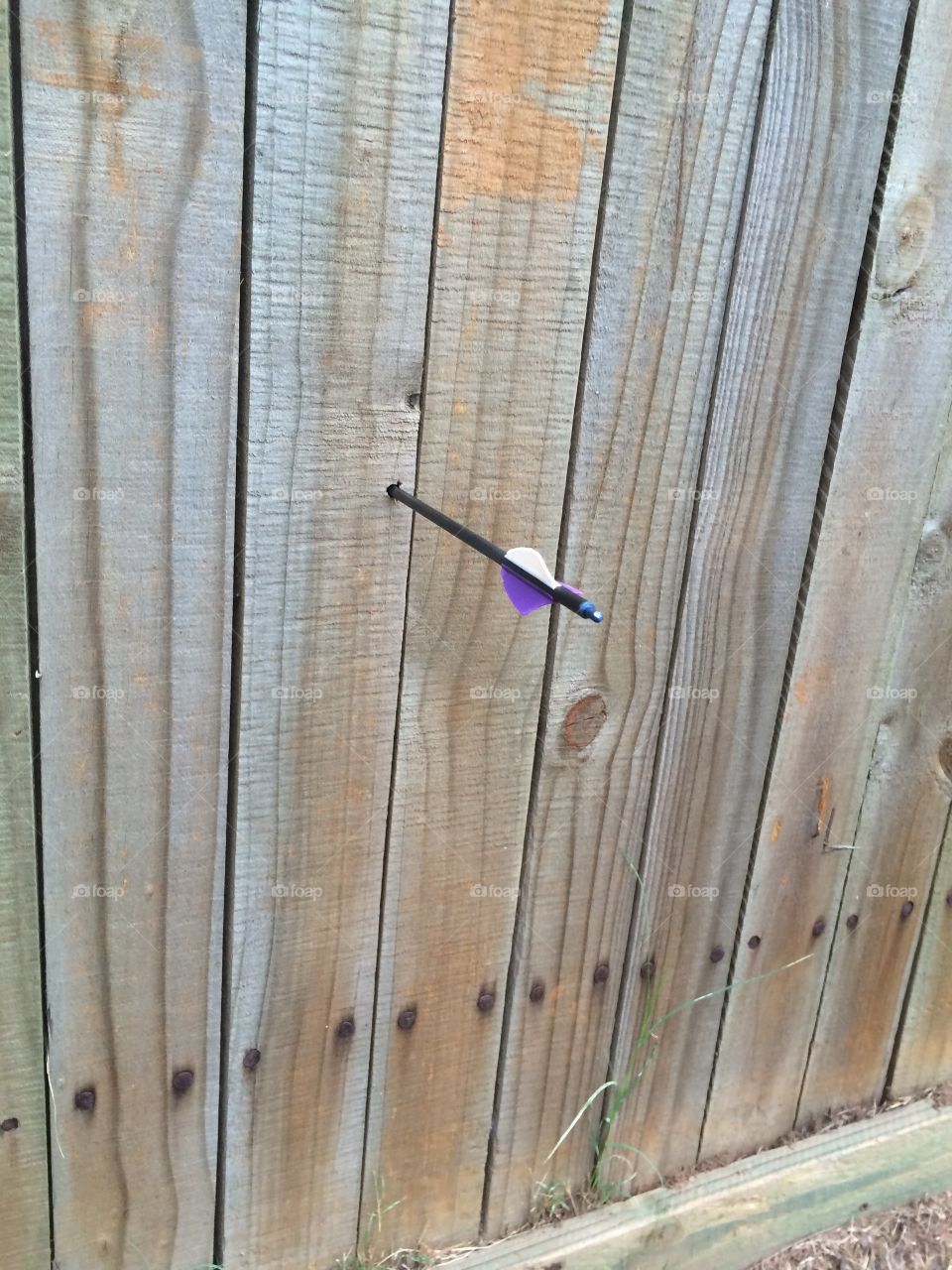 Arrow in wooden wall