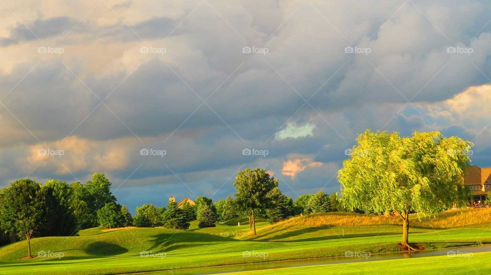 Storm clouds over green landscape