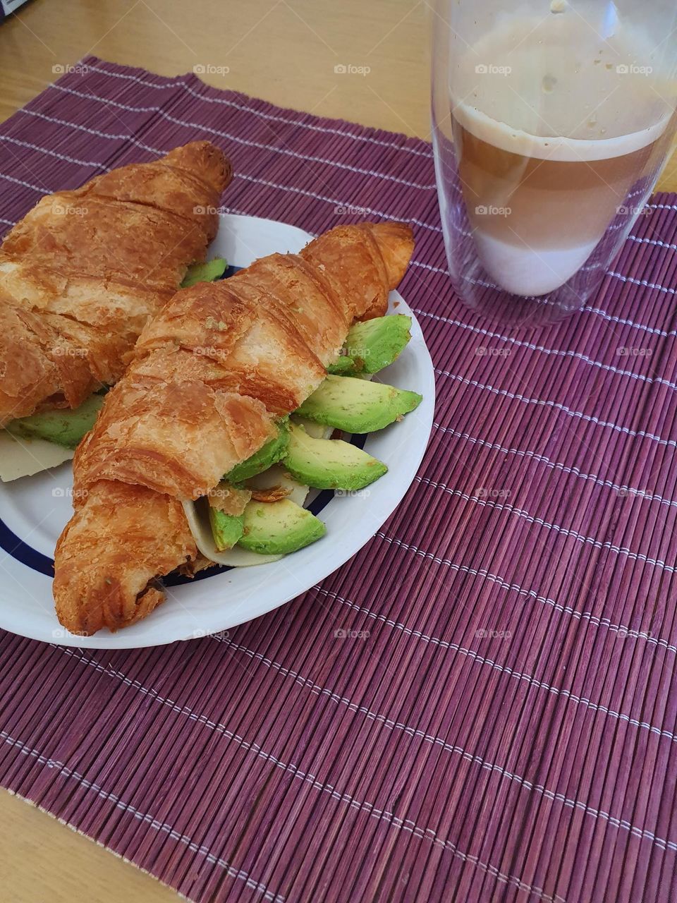 Nice avocado croissants with a cup of coffee.